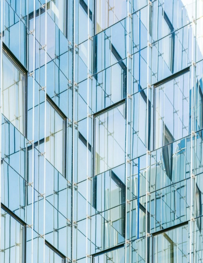 Close-up of a modern glass building facade with a geometric pattern.